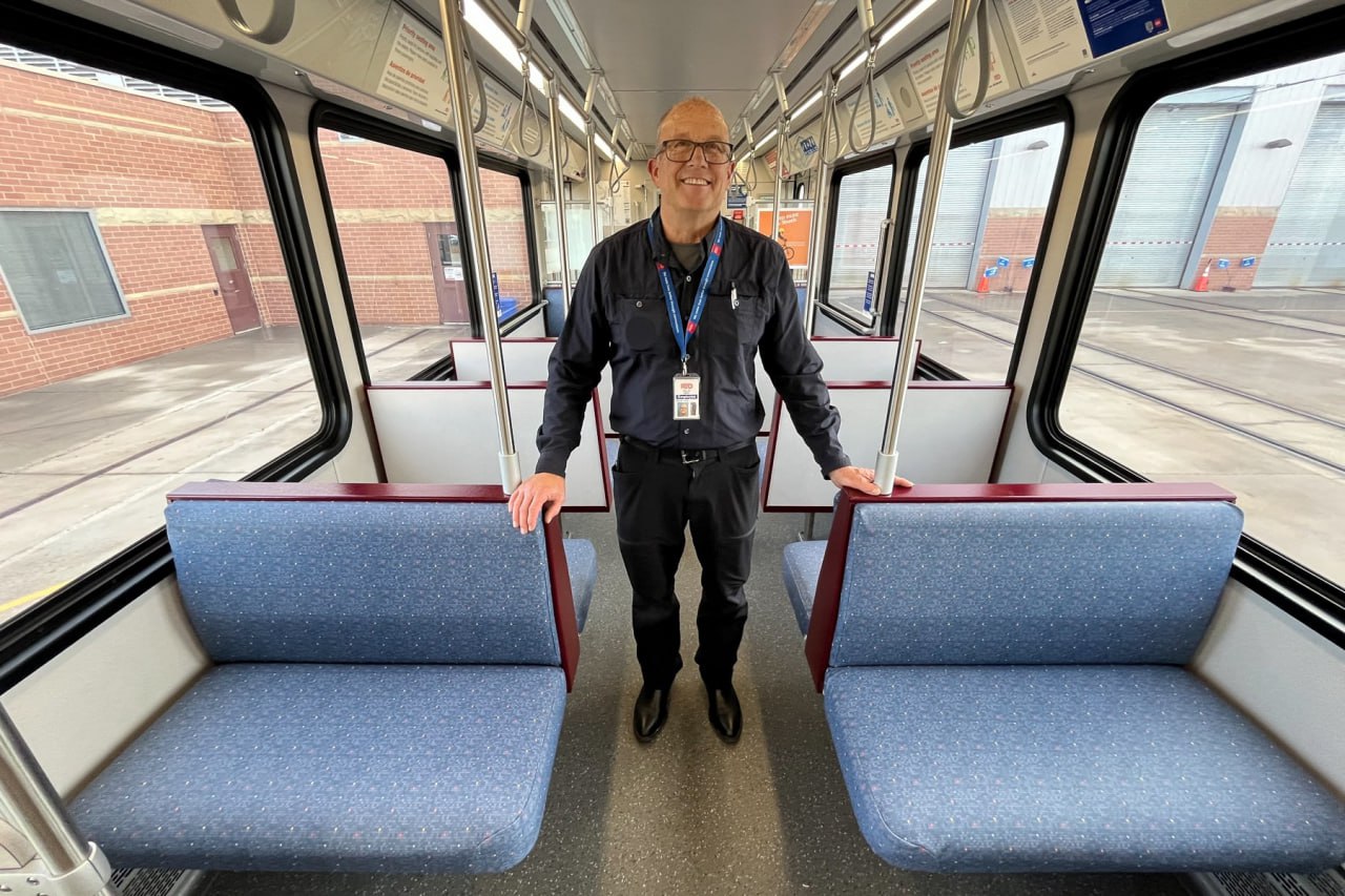 Phil Eberl, General Superintendent of Light Rail Vehicle Maintenance, in a train car with new vinyl seats, Englewood, Colorado