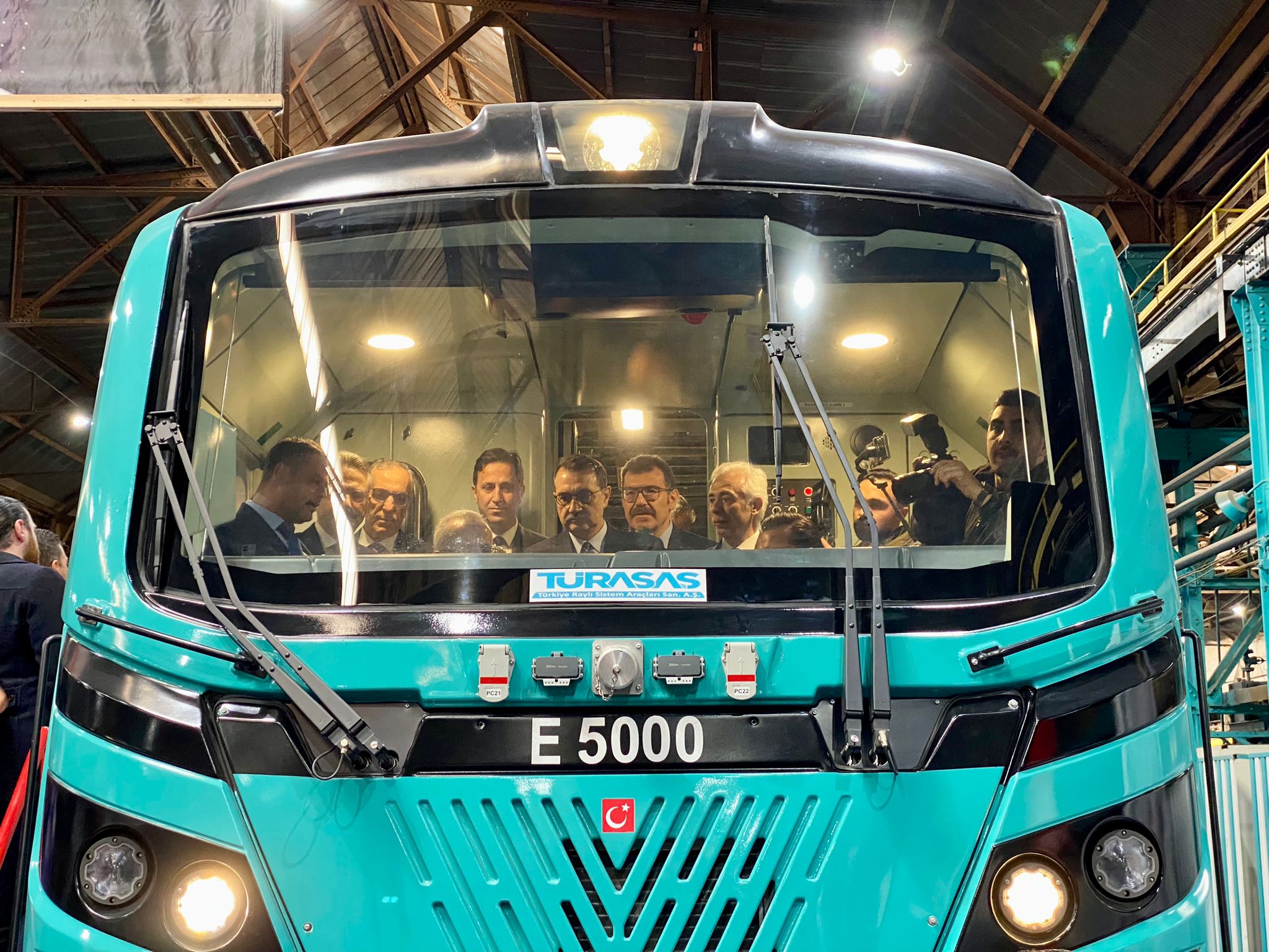 Attendees of the signing ceremony in the cab of the domestically designed E5000 electric locomotive at the Eskisehir site